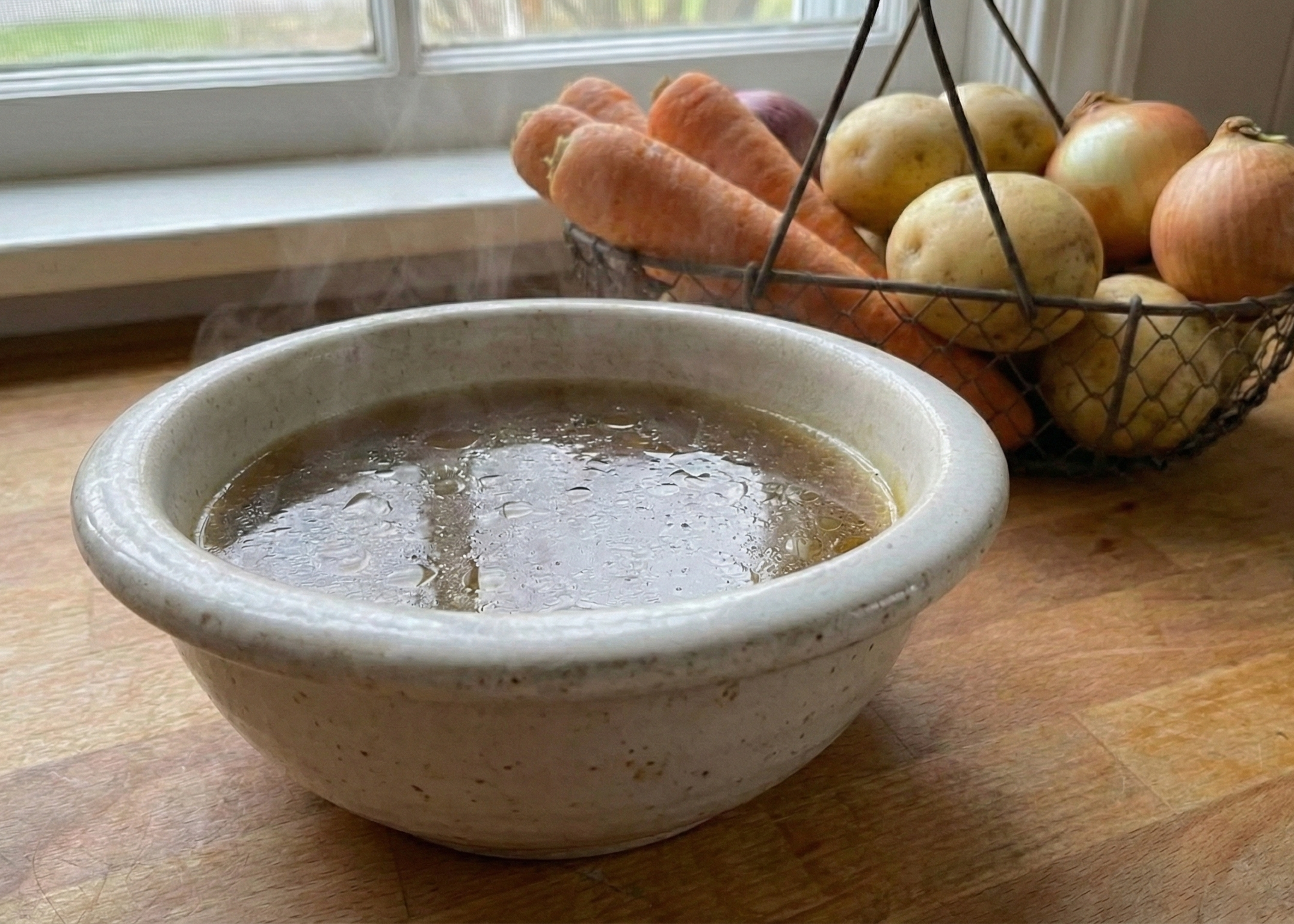Beef Broth - Grass-Fed on a wooden bowl