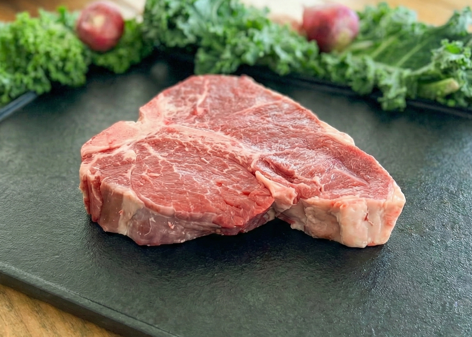 Beef Porterhouse Steak on a black pan 