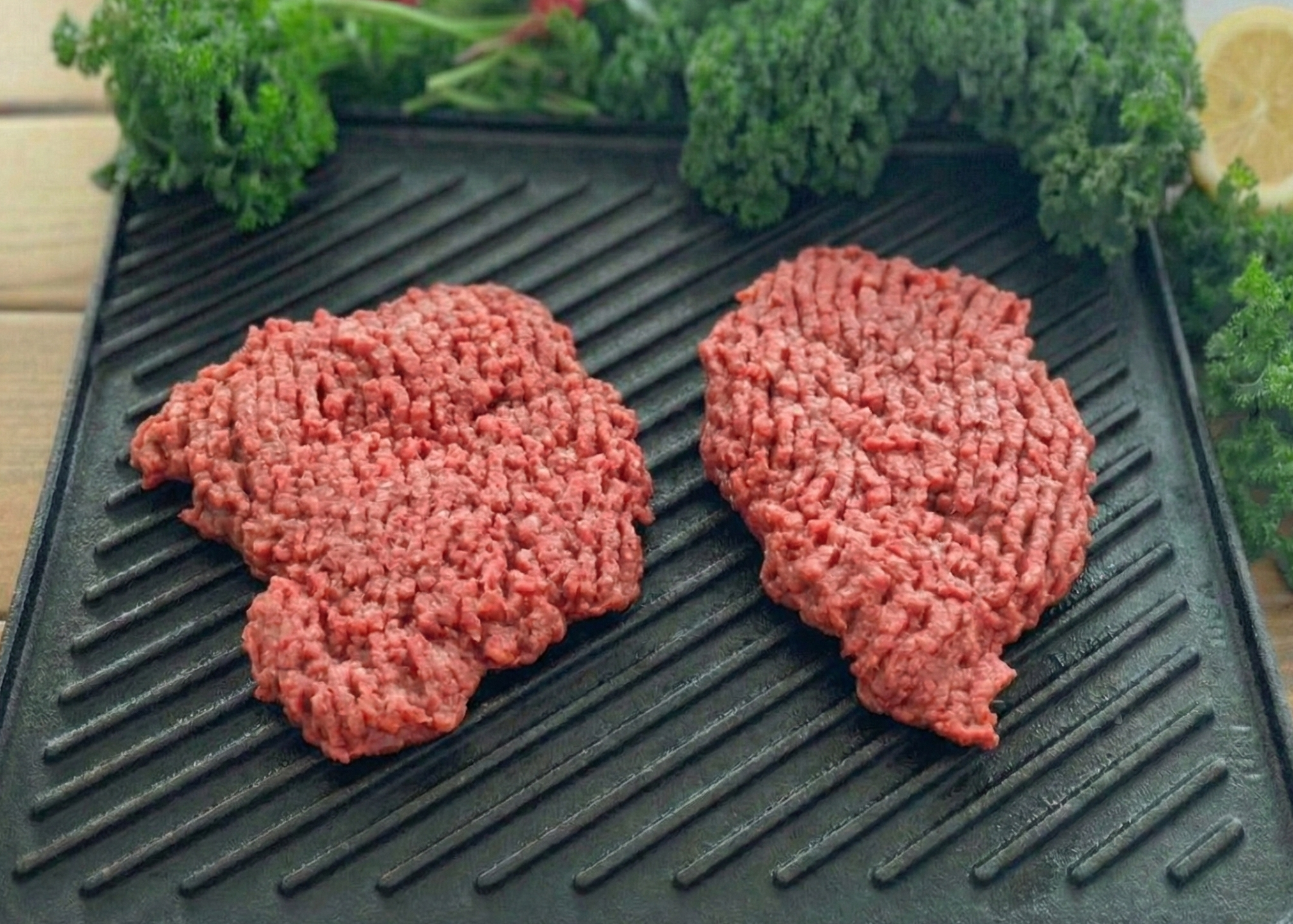 Buffalo Minute Steaks on a black pan 