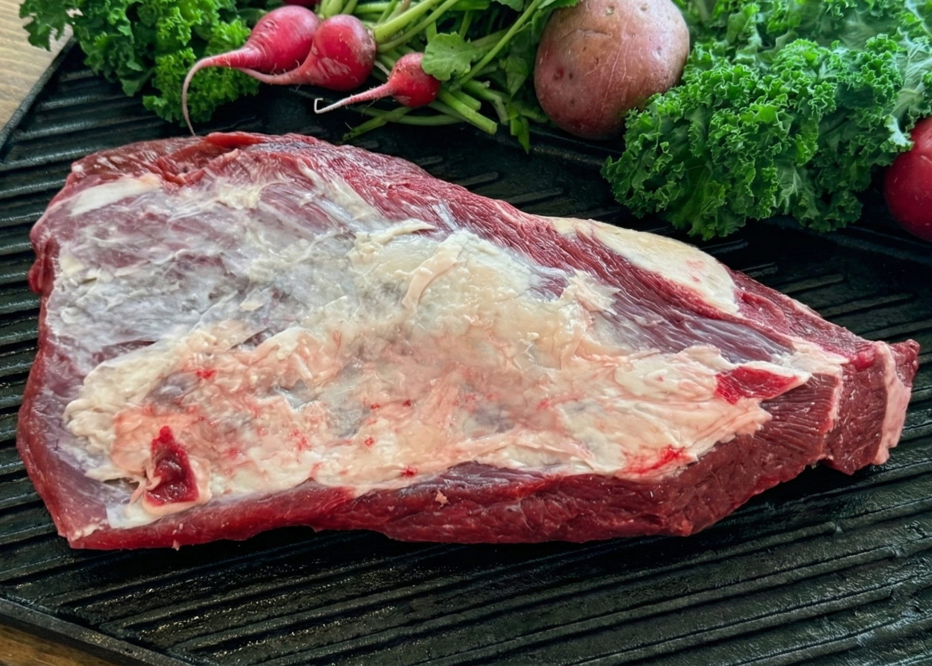 Grass Fed Beef Brisket on a black pan