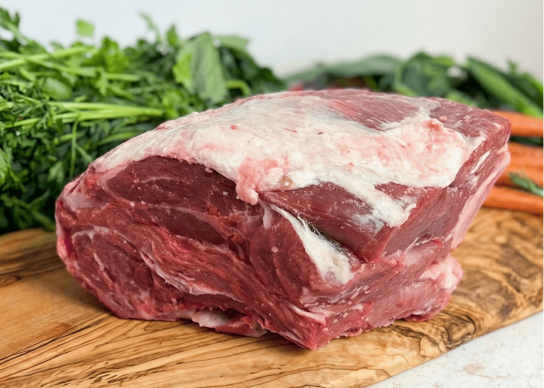 Lamb Arm Roast on a wood board