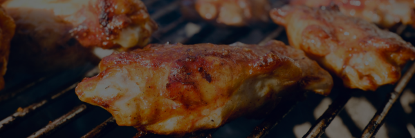 Chicken wings being grilled on a barbecue grill